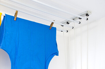 Residential ceiling clothesline with some T-shirts hanging