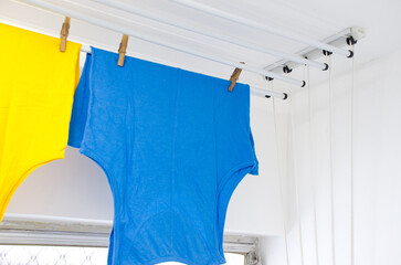 Residential ceiling clothesline with some T-shirts hanging