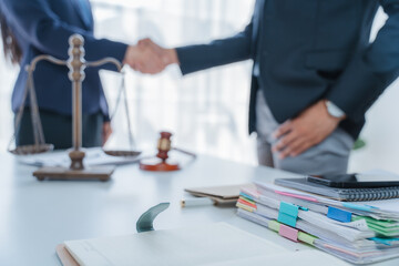 Lawyer engages with a smiling client during a legal consultation in a modern office.