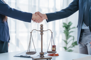 Lawyer engages with a smiling client during a legal consultation in a modern office.