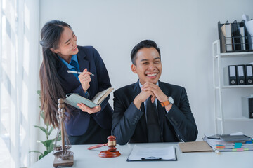 Lawyer engages with a smiling client during a legal consultation in a modern office.