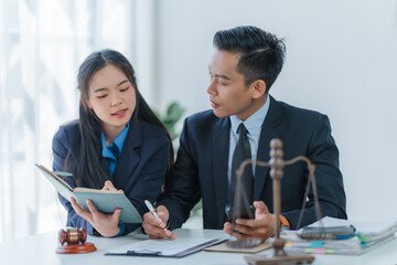 Lawyer engages with a smiling client during a legal consultation in a modern office.