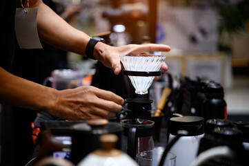 Close up hands Professional barista making filtered drip coffee in coffee shop