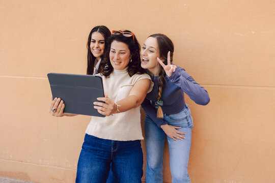 Women sharing a moment with a tablet