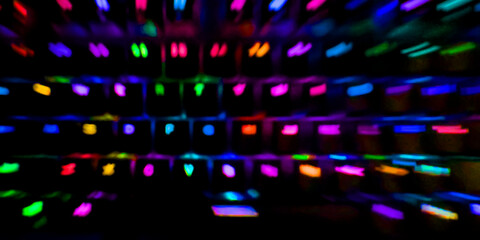 abstract background: glowing keys of a mechanical keyboard blurred