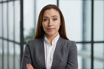 Confident business woman with arms crossed smiling at camera