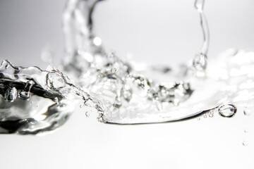 Blue water waves and bubbles on white background.