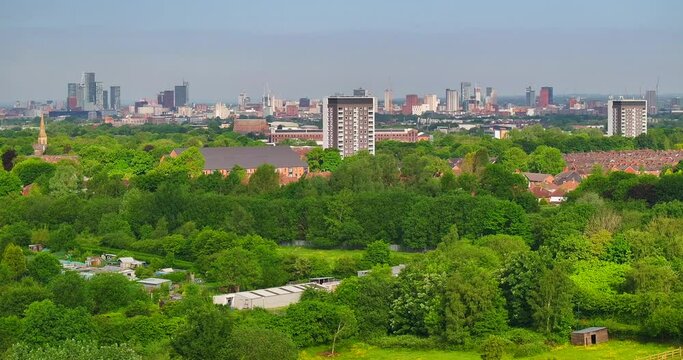 Aerial video of Gorton and Openshaw with Manchester skyline on the Horizon. 