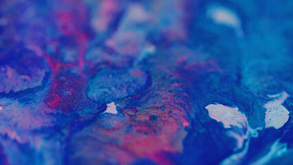 Glitter ink splash. Fluid spill. Defocused blue red color shimmering texture acrylic liquid paint...