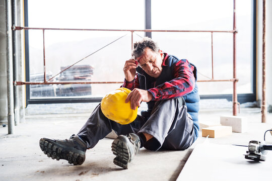 Injured worker with wound on head, head injury. Work injury, accident in workplace.