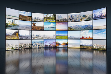 Creative video wall in television production room as technology concept with colorful screens and various images. TV monitors on light rooms with reflections on floor. 3D Rendering.