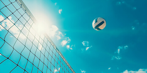 Volleyball flying in the air, white net, sunny blue sky backdrop, ideal for sports-related content, advertisements, concept of an active beach holiday,with copy space