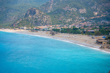 Aerial view of Oludeniz beach with people and boats in the morning, Coastline next to Fethiye, Turkey