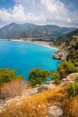 Fototapeta premium Aerial view of Oludeniz beach with people and boats in the morning, Coastline next to Fethiye, Turkey