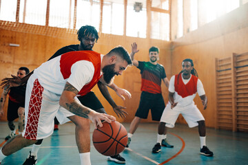 Diverse professional team playing basketball at the gymnasium or a sports hall
