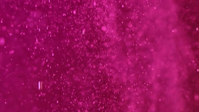 Small purple bubbles rise in the water