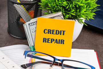 Business, finance and fix your credit here concept. Concept words CREDIT REPAIR on a yellow sticker...