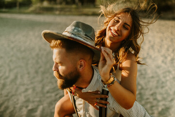 Portrait of happy fun rancher couple having piggyback ride at ranch.