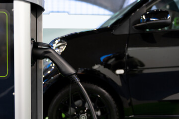 Close-up of a electric charging station on the background of electric car.