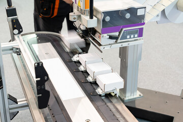 Machine for labeling barcodes on boxes.
