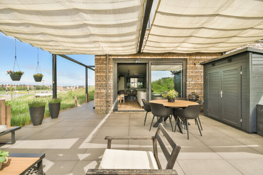 Stylish patio setup with canopy and dining area at Duintopstraat