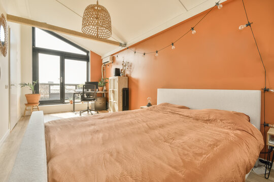 Stylish bedroom with orange walls and modern decor