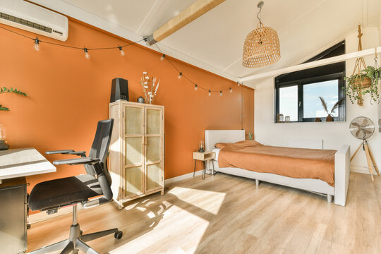Modern bedroom with orange walls and trendy decor at Duintopstraat