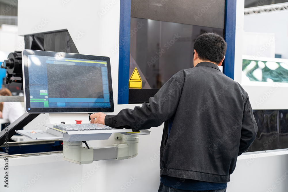 Poster The operator operates an automatic machine for cutting metal. Smart factory..