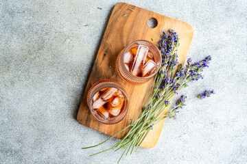 Cognac cocktails with lavender on a wooden board