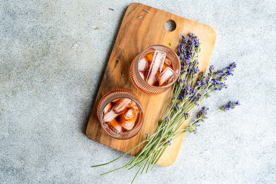 Cognac cocktails with lavender on a wooden board