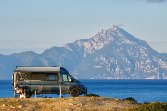 Camper van parked by the sea with a stunning view of Mount Athos in the background, capturing the essence of adventure and outdoor living in Greece.