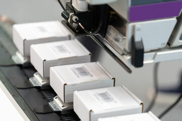 Machine for labeling barcodes on boxes.