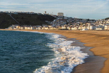 View of the city and the beach 'Praia da Nazar&eacute;' at sunset in Nazar&eacute;, Portugal