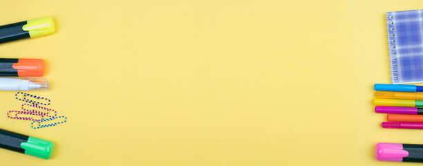 Back to school. Stationery on a yellow table. Office desk with copy space. Flat lay. Banner