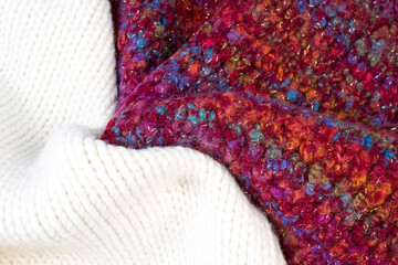 Knitted woolen sweaters. A bunch of knitted winter, autumn clothes, sweaters, knitwear, space for the text.