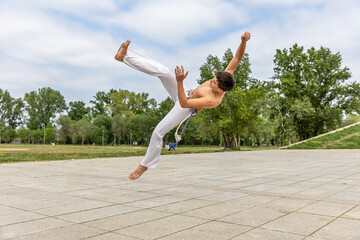 Teenager practicing capoeira , brazilian martial art