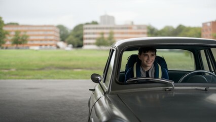 A man sitting in a car smiling at the camera, AI