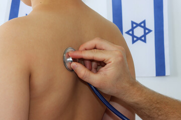 Pediatric medicine in Israel - doctor listening to child with stethoscope