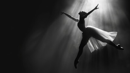 Bold black and white artistic portrait of a ballet dancer mid-pose, captured with dynamic light and shadow