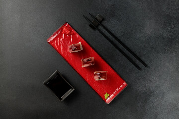 Japanese food: sushi, roll with tuna, tiger shrimp, unagi, Philadelphia. Black background