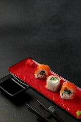 Japanese food: sushi, Classic Philadelphia roll with shrimp and salmon. Black background