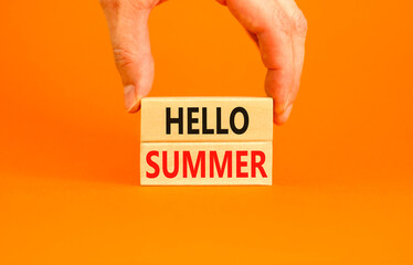 Hello summer symbol. Concept words Hello summer on beautiful wooden block. Beautiful orange paper...