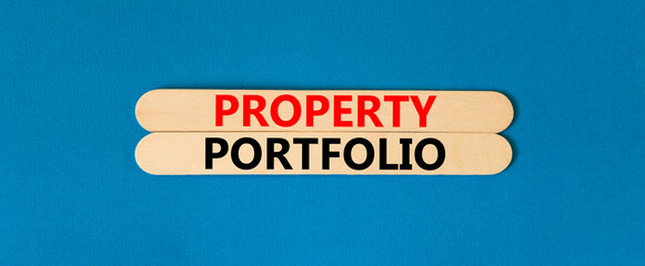 Property portfolio symbol. Concept words Property portfolio on beautiful wooden stick. Beautiful blue paper background. Business Property portfolio concept. Copy space.