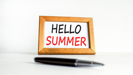 Hello summer symbol. Concept words Hello summer on beautiful wooden picture frame. Beautiful white paper background. Black pen. Business lifestyle Hello summer concept. Copy space.