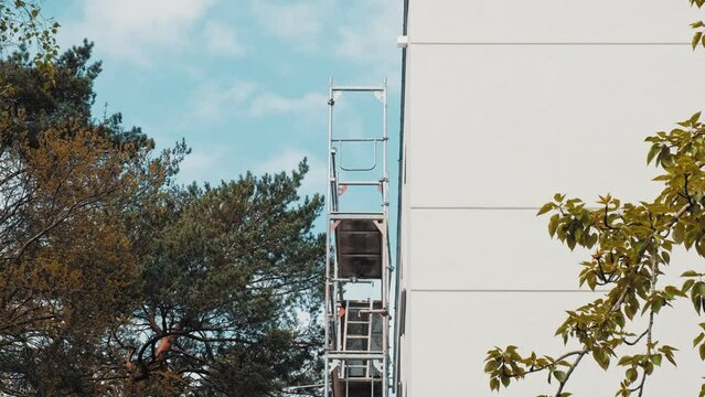 Metal Construction Site Scaffolding Used during Building Thermal Modernization for Compliance with European Green Deal Regulations