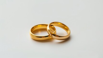 Gold Wedding Rings on White Background. Symbolic of Love and Marriage