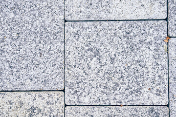 The surface of a square gray tile. Stone texture of street tiles. With space to copy. High quality...