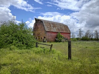 Old red barn in the field.