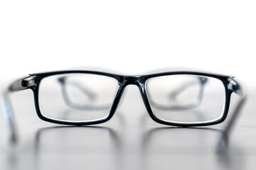 Fototapeta premium Close-up photo of sight eyeglasses is on the wooden table