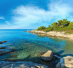 Aegean sea coast landscape with aquamarine water, view from Orange Beach (Chalkidiki, Greece). People unrecognizable.